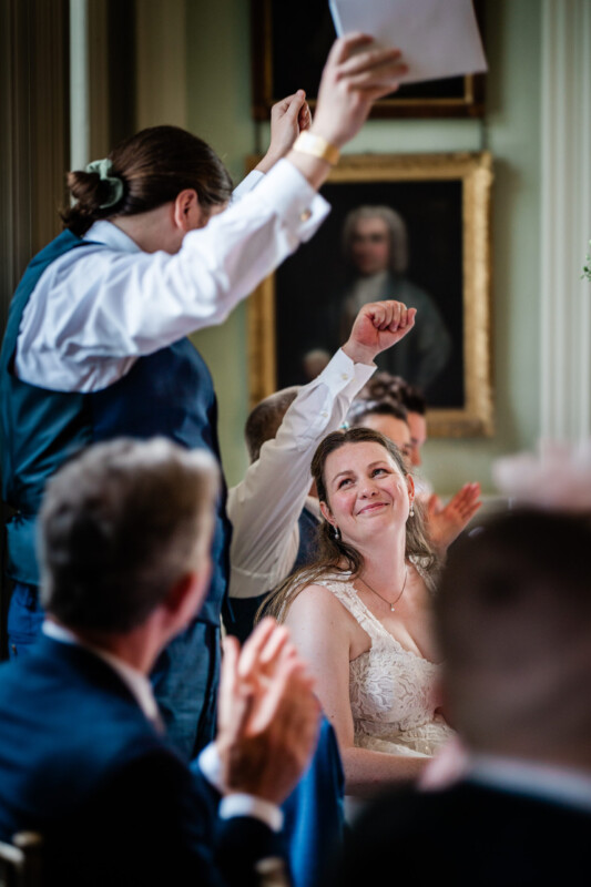 A documentary wedding photography capture of a bride during the groom's speech, at Davenport House, an english country house wedding venue