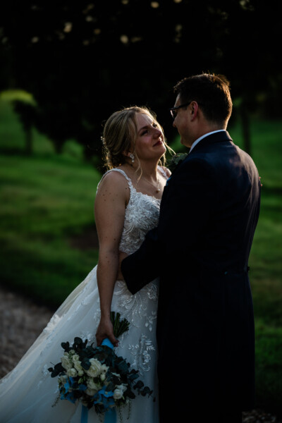 Candid couple photos of a bride and groom at golden hour, during a wedding at Pynes House