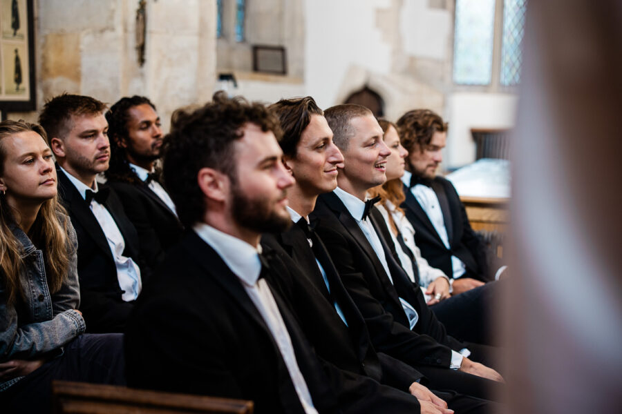 Candid Cotswolds wedding photography of guests during a wedding ceremony