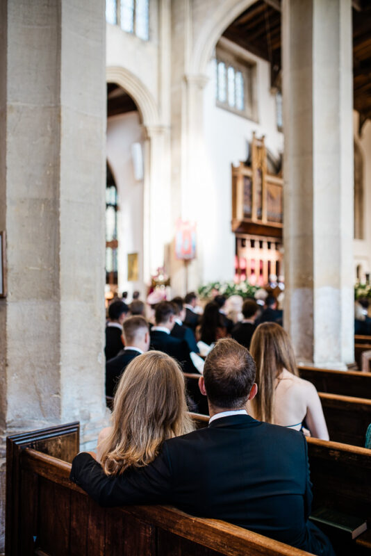 Candid Cotswolds wedding photography of guests during a wedding ceremony