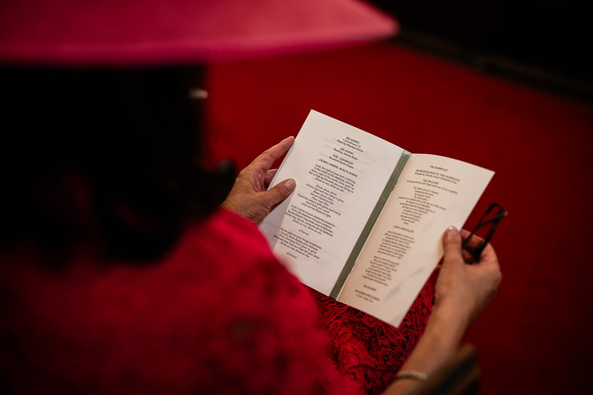 Candid Cotswolds wedding photography of guests during a wedding ceremony