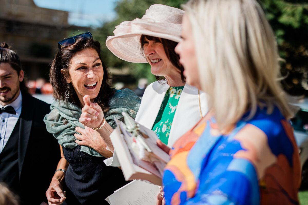 Candid Cotswolds wedding photography of guests during a wedding ceremony