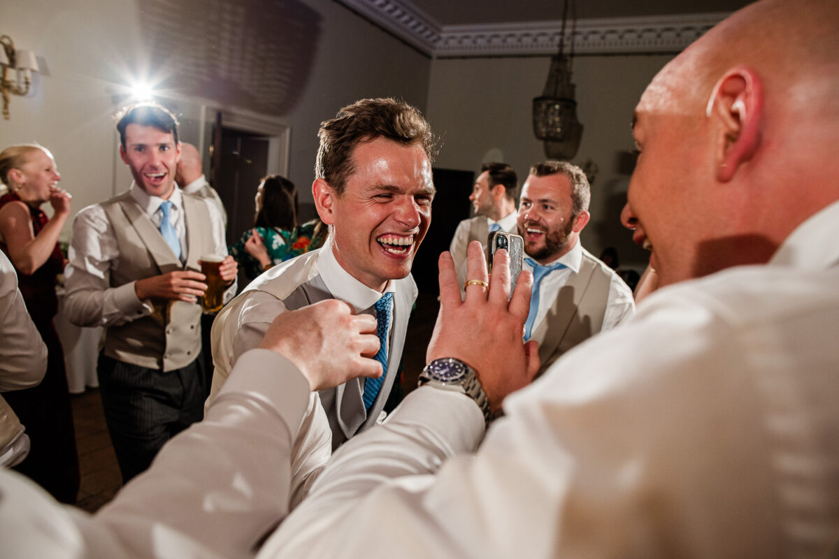 Candid wedding photography during dancing at Pynes House wedding venue
