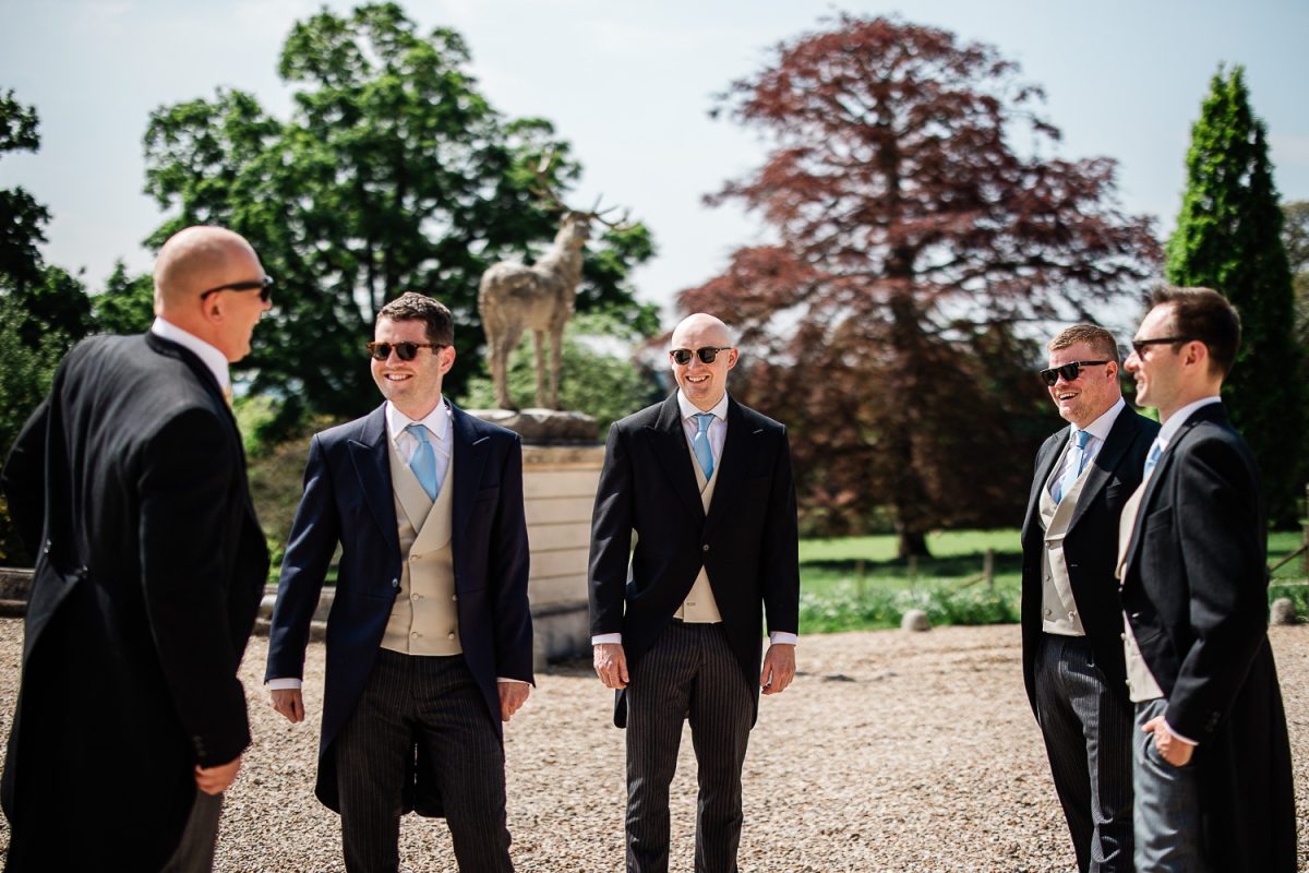 Candid captures during groom prep at Pynes House wedding venue in Devon
