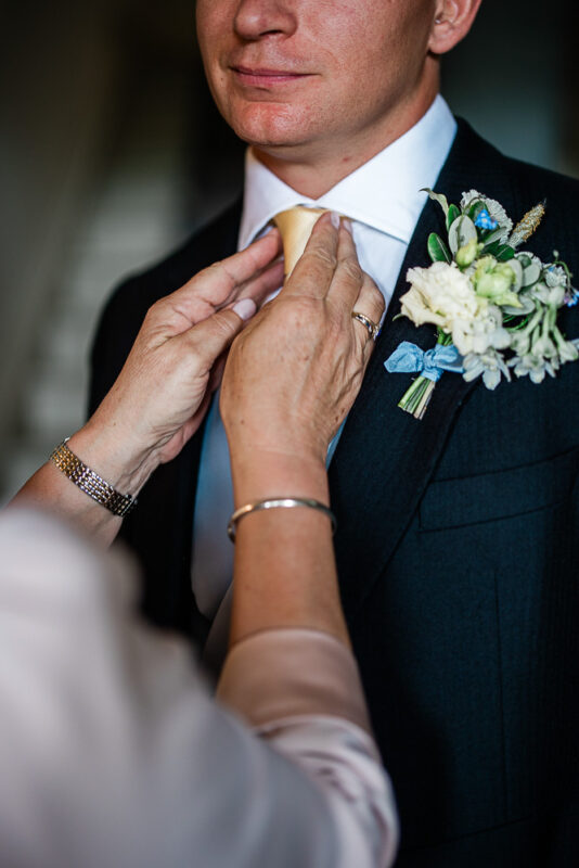 Candid morning preparations at Pynes House, captured by a documentary wedding photographer at Pynes House